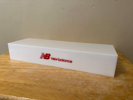 white pedestal shoe riser with logo